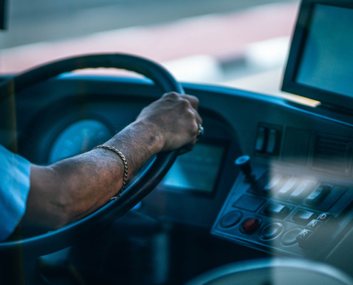 Side view of a bus driver during the day