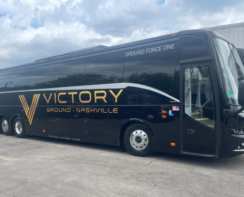 Side view of a Victory Grounds Charter bus