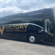 Side view of a Victory Grounds Charter bus